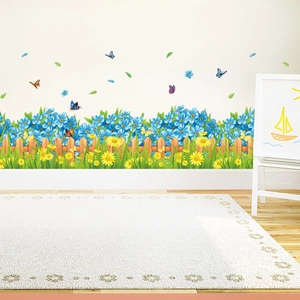 Garden fence wall decal with yellow daisies, blue flowers and colorful butterflies