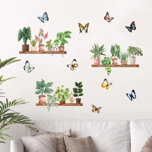 Detail of hand-painted watercolor butterfly and potted plant wall decals on a clean wall