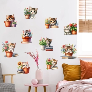 Detail of cartoon cat wall stickers with potted plants and sunflowers on a living room wall