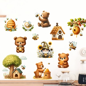 Detail view of cartoon bear and bee wall stickers applied to a clean white home wall