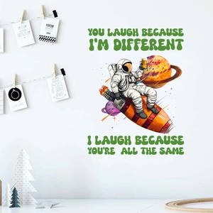 Detail of creative astronaut wall sticker with rocket and planet on clean white wall decor