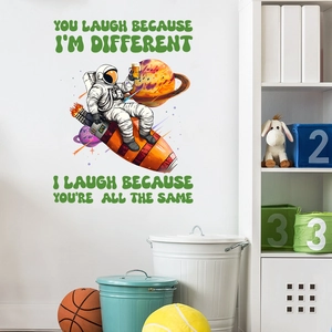 Macro shot of astronaut on rocket wall sticker with green quote on a white home wall