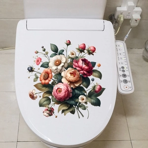 Detail view of colorful peony and rose floral decals on a white toilet cover surface