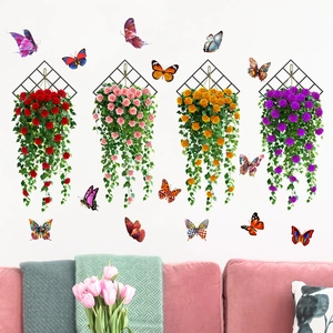 Detail of hanging artificial rose vines with black mesh grids and 3D butterfly wall stickers