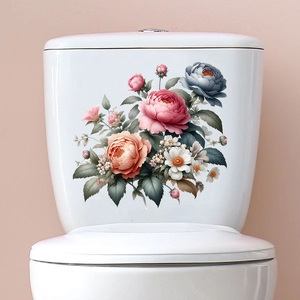 Detailed close-up of pink and orange floral decals on a white ceramic toilet tank surface