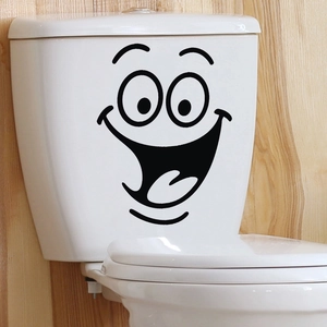 Waterproof black vinyl smile face wall sticker applied to a white ceramic toilet tank surface