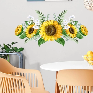 Detailed close-up of sunflower wall sticker with green leaves on a light colored wall