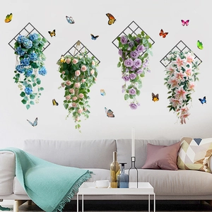 Detailed wall decor with artificial flowers and butterflies on black metal frames