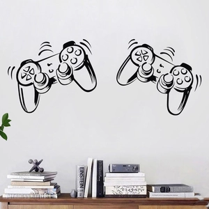 Detailed view of two black video game controller wall stickers on a white modern wall