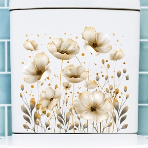 Detail of waterproof gold and white floral wall decals on a ceramic bathroom tank