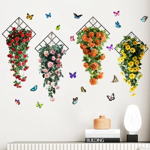 Detail of waterproof wall stickers showing colorful butterflies and floral vines on a white wall