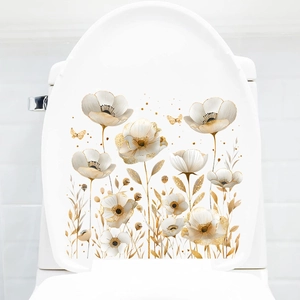 Close-up of golden and white floral toilet stickers with butterflies and metallic textures