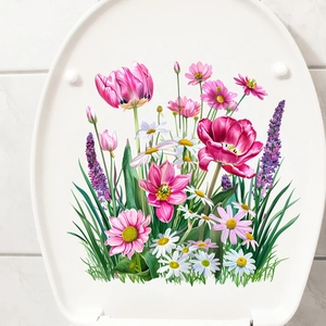 Close-up of waterproof tulip and daisy stickers applied on a white toilet lid surface