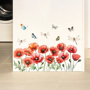 Detail of red poppy and butterfly wall decals applied to a white modern cabinet surface