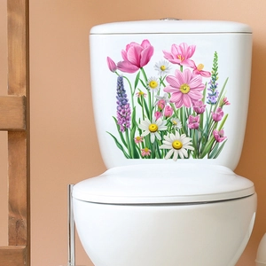 Detailed close-up of self-adhesive floral tulip and daisy stickers on a white toilet tank