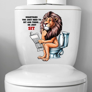 Detail of funny lion reading newspaper sticker on white ceramic toilet tank surface
