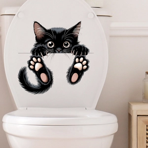 Detailed view of a black peeping cat wall sticker with cute paws on a white toilet surface