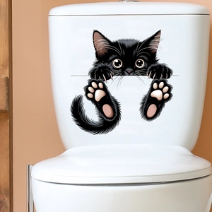 Close-up of 3D funny black peeking cat waterproof wall sticker on white toilet tank