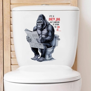 Detail of funny gorilla reading newspaper toilet sticker with creative English slogan