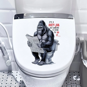 Close-up of funny gorilla reading newspaper waterproof sticker on a white toilet lid