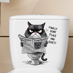 Funny black cat reading newspaper sticker on a white toilet tank in a bathroom
