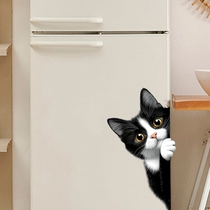 Detail showing a 3D peeping black and white cat wall sticker on a white fridge surface