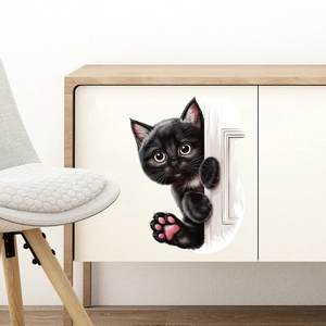 Detail of 3D peeking black cat wall sticker with pink paws on white cabinet surface