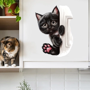 Detailed view of a 3D funny black peeking cat wall sticker on white cabinet door