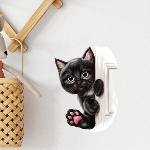 Close-up of 3D black peeking cat wall sticker with large eyes on a white door