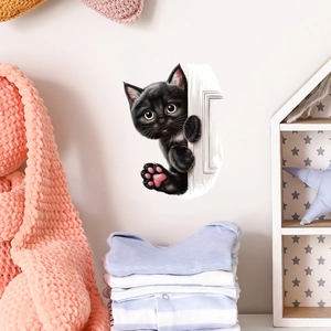 Close-up of 3D black peeking cat wall sticker applied on a white surface in a cozy room