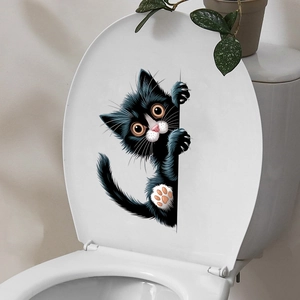 Close-up of waterproof black and white peeking cat wall sticker applied on a white surface