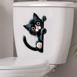 Close-up of a funny black peeping cat waterproof sticker on a white ceramic surface