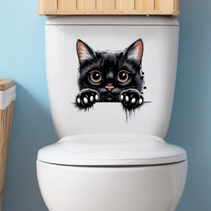 Close-up of 3D peeping black cat waterproof sticker applied on a white toilet tank