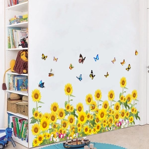 Detail of sunflower and butterfly wall stickers applied on white bedroom wall with bookshelf
