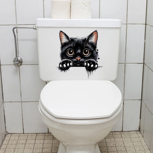 Detail of waterproof black peeking cat sticker applied on a white bathroom toilet surface