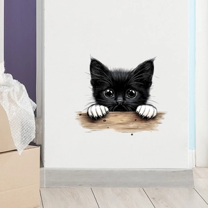 Detailed close-up of a 3D funny black peeking cat wall sticker on a white indoor wall