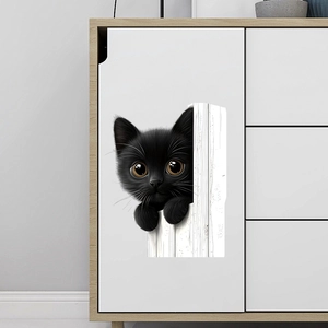 Detail of 3D funny black peeking cat wall sticker on a white wooden furniture surface