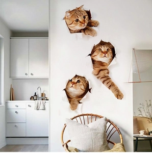 Detailed view of three 3D ginger cat wall decals with realistic cracked wall hole effect