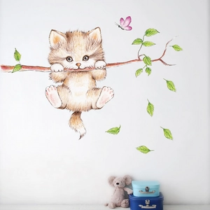 Detail of 3D cartoon cat wall sticker hugging a tree branch with butterflies and leaves