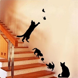 Detail of 3D black cat wall stickers featuring silhouettes of cats and butterflies on a wall