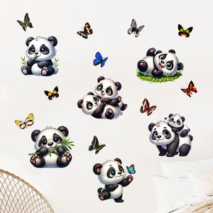 Detail of cute panda and butterfly wall stickers on white wall in a cozy bedroom