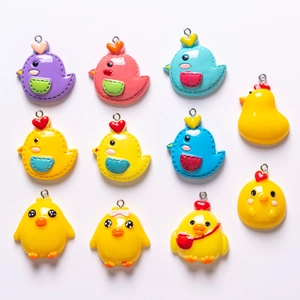 Close-up of assorted mini resin chick charms in various colors for DIY handmade jewelry