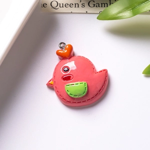 Close-up of a pink resin cartoon bird charm with heart detail for DIY keychains