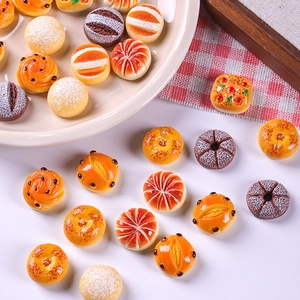 Detailed macro view of assorted miniature resin bread and pastry models for dollhouses