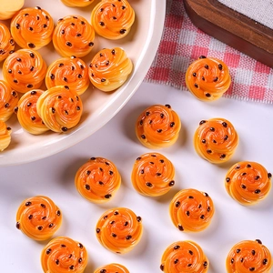 Macro shot of miniature resin bread dollhouse decor with detailed orange spiral texture