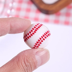 Miniature resin baseball bead with red stitching detail for DIY jewelry making