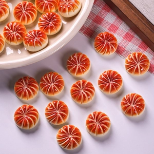 Detailed close-up of miniature pumpkin-shaped resin food charms for DIY dollhouse decor