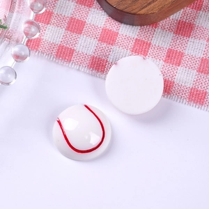 Detailed view of DIY resin baseball charms with red stitching for sports crafts