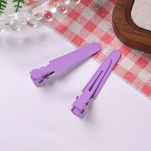 Close-up of lavender purple metal duckbill hair clips for DIY handmade crafts and styling