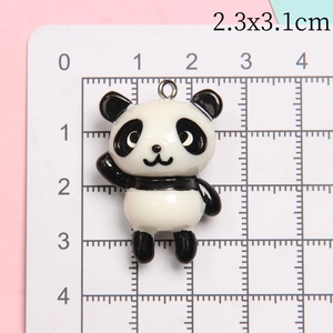 Detail of 2.3x3.1cm resin panda pendant with a metal ring on scale measurement board